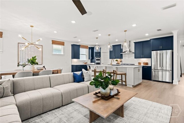 323 Birch Dr, Richmond Hill, GA 31324 - living room with a chandelier, recessed lighting, and light wood-style floors
