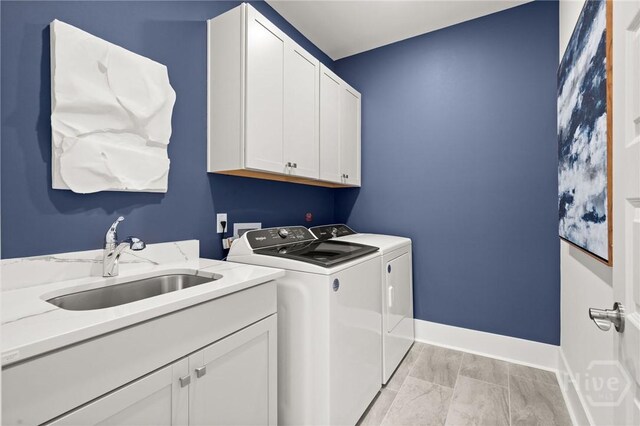 323 Birch Dr, Richmond Hill, GA 31324 - washroom with washer and clothes dryer, cabinet space, and baseboards