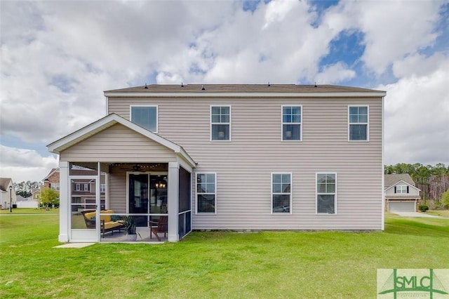 back of property featuring a sunroom and a yard