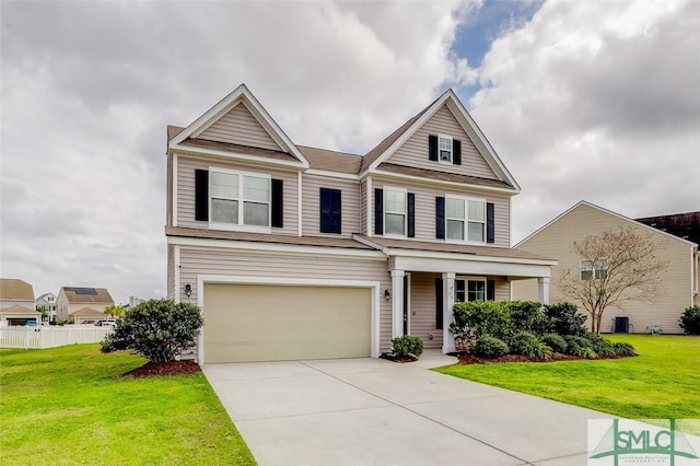 view of front of home featuring concrete driveway, a front lawn, an attached garage, and fence