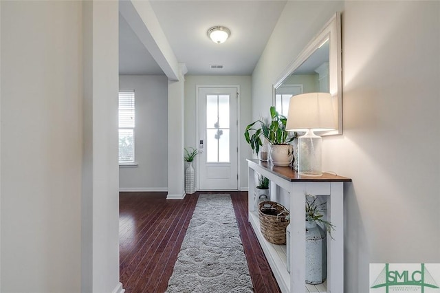 entryway with visible vents, baseboards, and wood finished floors