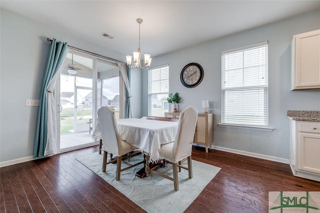 dining area with a notable chandelier, dark wood finished floors, visible vents, and baseboards