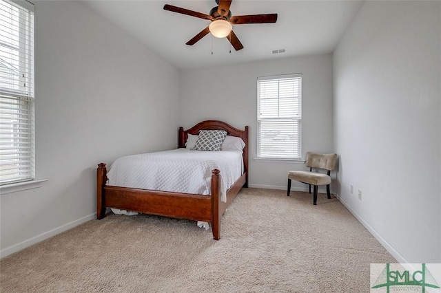 bedroom featuring carpet floors, a ceiling fan, visible vents, and baseboards