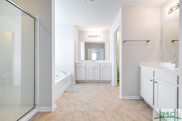 full bathroom featuring a garden tub, a stall shower, a sink, and toilet