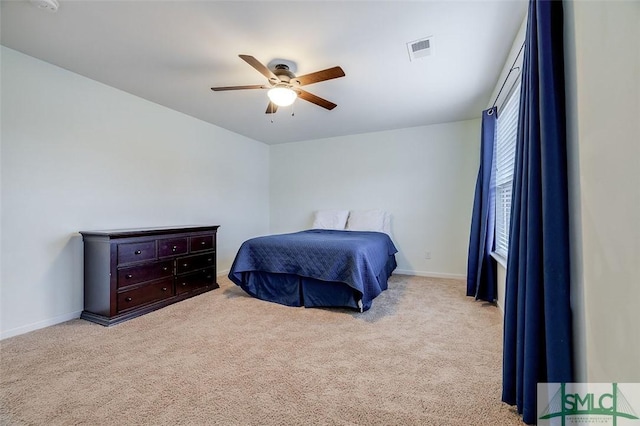 bedroom featuring a ceiling fan, baseboards, visible vents, and carpet flooring