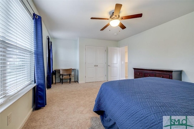 carpeted bedroom with a ceiling fan, a closet, and baseboards