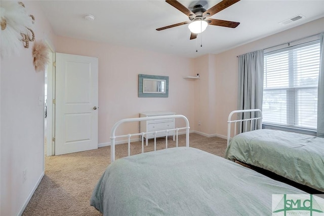 bedroom featuring a ceiling fan, baseboards, visible vents, and carpet flooring