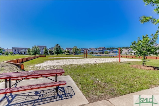 view of property's community featuring a yard, a residential view, and volleyball court