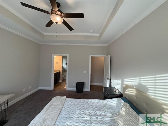 119 Sams Dr, Guyton, GA 31312 - bedroom featuring a tray ceiling, dark carpet, crown molding, baseboards, and ceiling fan