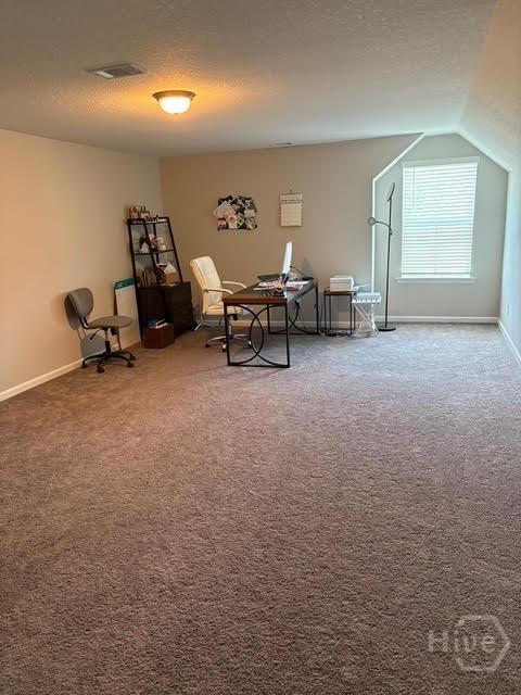119 Sams Dr, Guyton, GA 31312 - living area featuring carpet floors, baseboards, and vaulted ceiling
