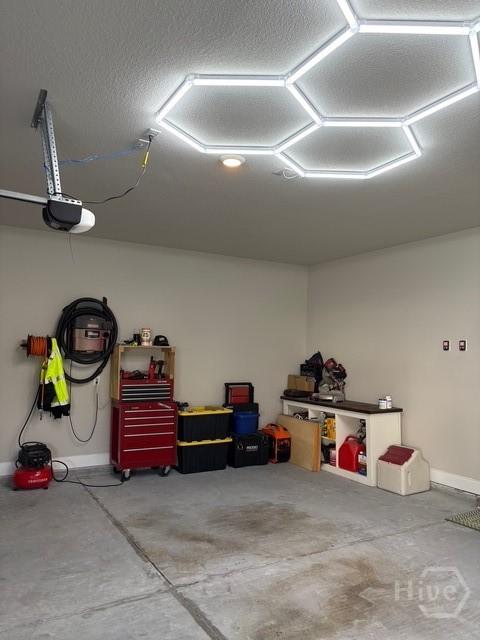 119 Sams Dr, Guyton, GA 31312 - garage with a garage door opener and baseboards