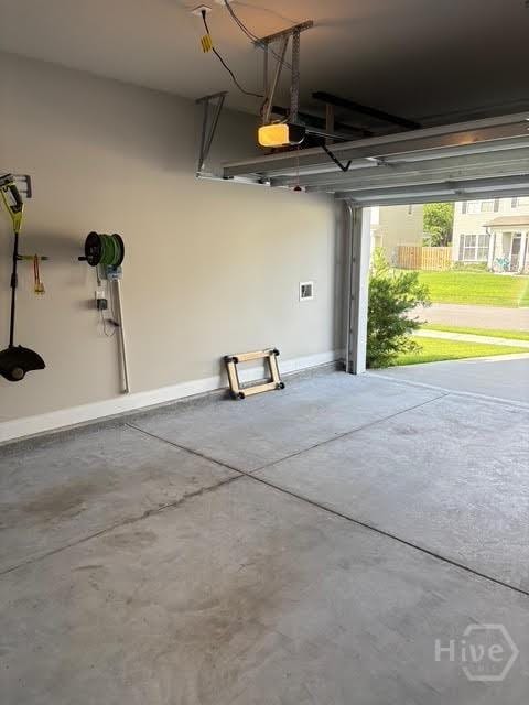 119 Sams Dr, Guyton, GA 31312 - garage featuring a garage door opener and baseboards