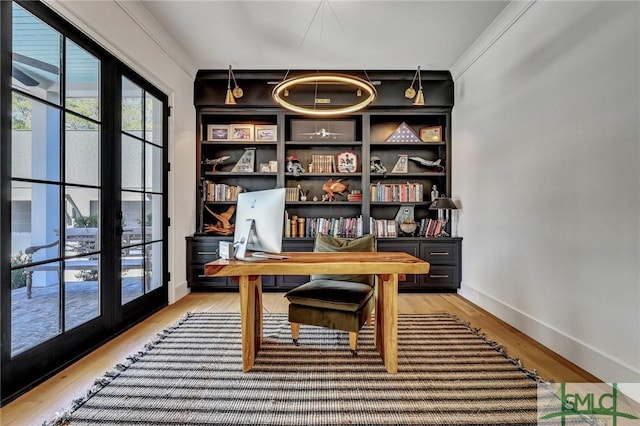 office area with light wood-style flooring and baseboards