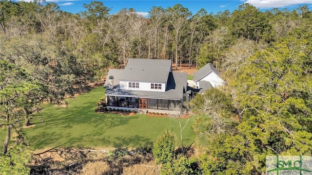 birds eye view of property with a forest view