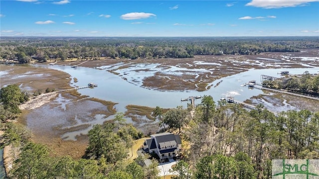 aerial view with a water view and a forest view