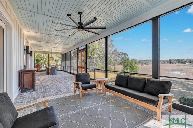 sunroom / solarium featuring wooden ceiling and ceiling fan