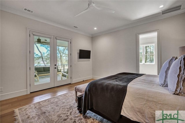 bedroom featuring french doors, wood finished floors, visible vents, and access to exterior