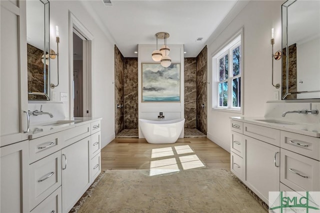 full bathroom with walk in shower, a sink, and wood finished floors