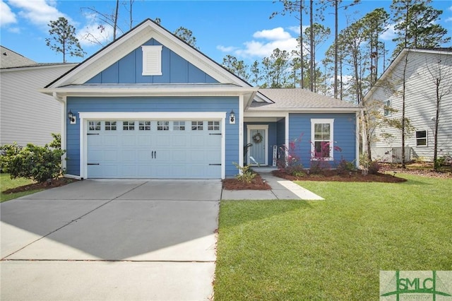 view of front of property featuring board and batten siding, a front yard, driveway, and a garage