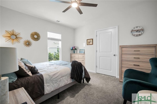 carpeted bedroom with baseboards, visible vents, and a ceiling fan