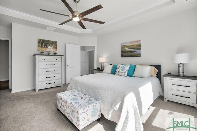 bedroom featuring visible vents, a raised ceiling, ceiling fan, ornamental molding, and carpet flooring