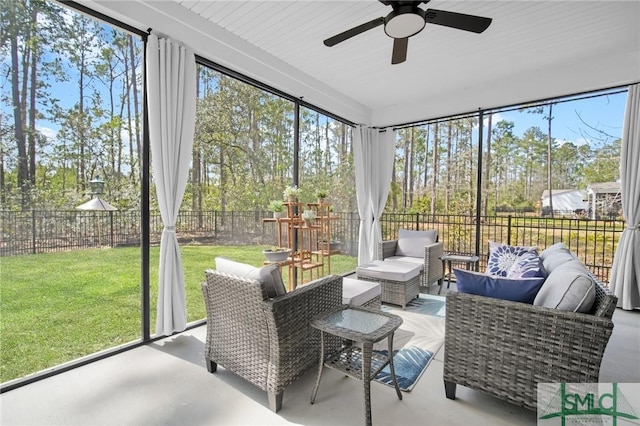 sunroom featuring a ceiling fan