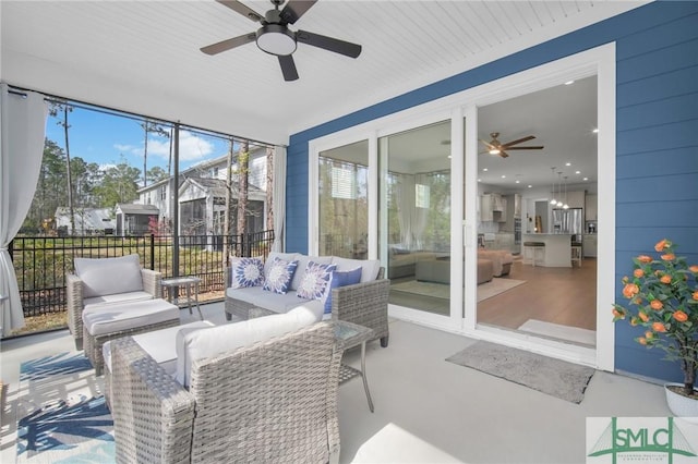 sunroom / solarium featuring ceiling fan