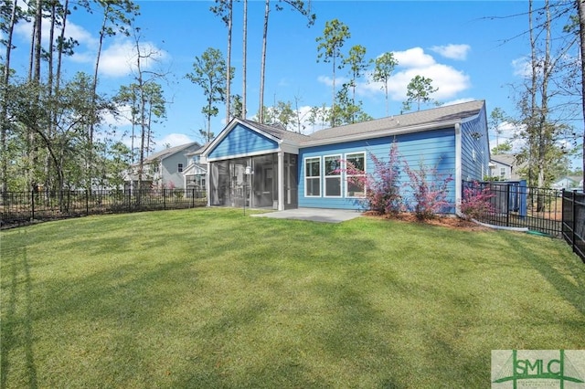 back of house featuring a sunroom, a fenced backyard, and a yard