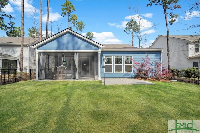 rear view of property featuring a yard, a patio, a fenced backyard, and a sunroom