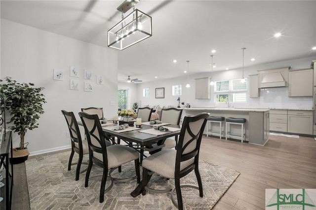 dining area featuring light wood-style floors, ceiling fan, baseboards, and recessed lighting