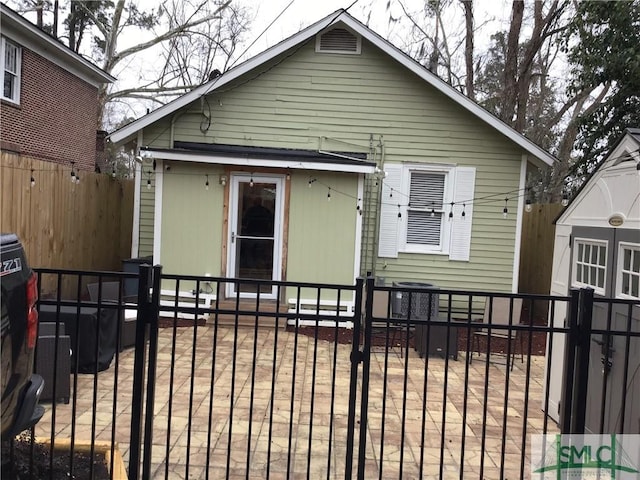 bungalow with a fenced front yard and central AC unit