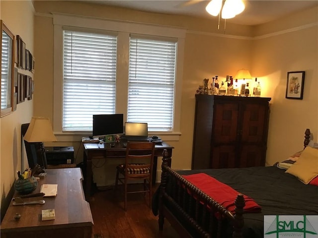 bedroom featuring multiple windows, crown molding, and wood finished floors