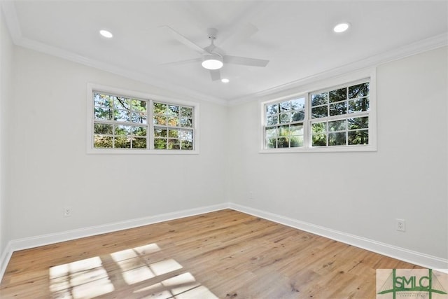 spare room featuring light wood-style floors, a healthy amount of sunlight, and crown molding