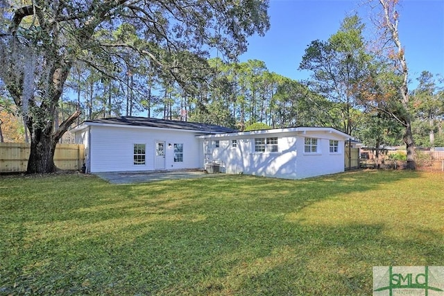 back of house with a yard, central AC unit, a patio area, and fence