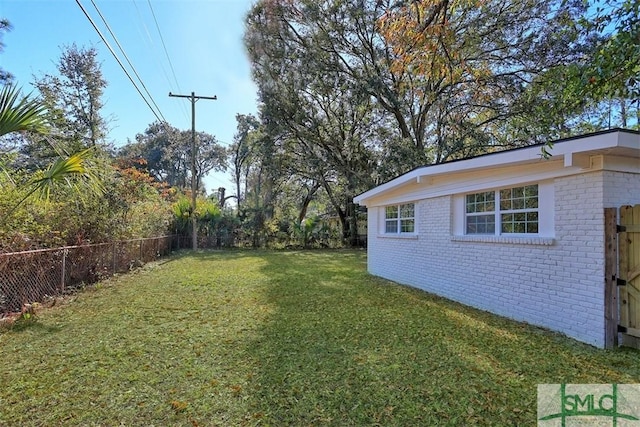 view of yard with a fenced backyard and an outdoor structure