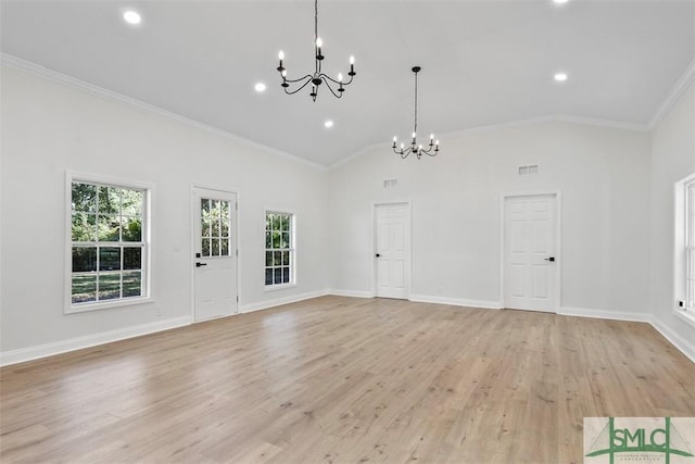 interior space with visible vents, baseboards, light wood-style flooring, ornamental molding, and a chandelier