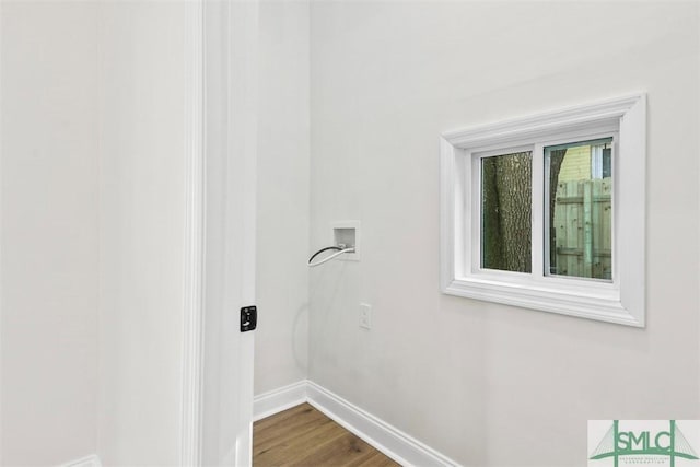 laundry room with dark wood-style floors, laundry area, washer hookup, and baseboards