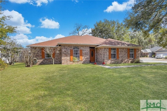 ranch-style house featuring brick siding and a front yard