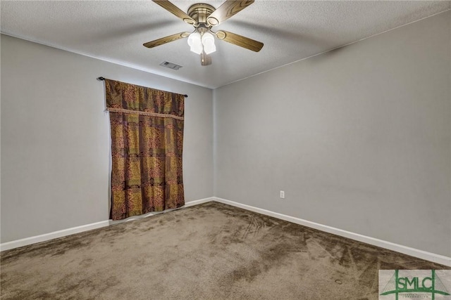 empty room with carpet floors, ceiling fan, visible vents, and baseboards