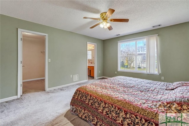 bedroom featuring baseboards, a textured ceiling, visible vents, and carpet flooring