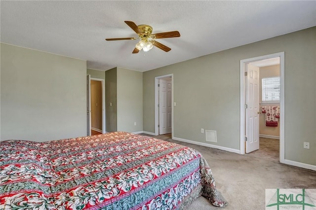 carpeted bedroom with a textured ceiling, a ceiling fan, and baseboards