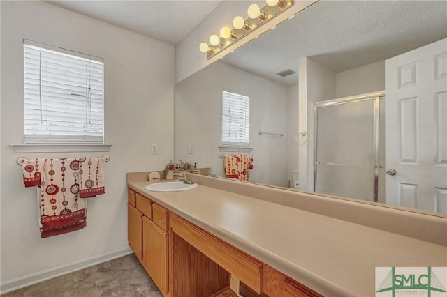 full bath with a stall shower, baseboards, visible vents, toilet, and vanity