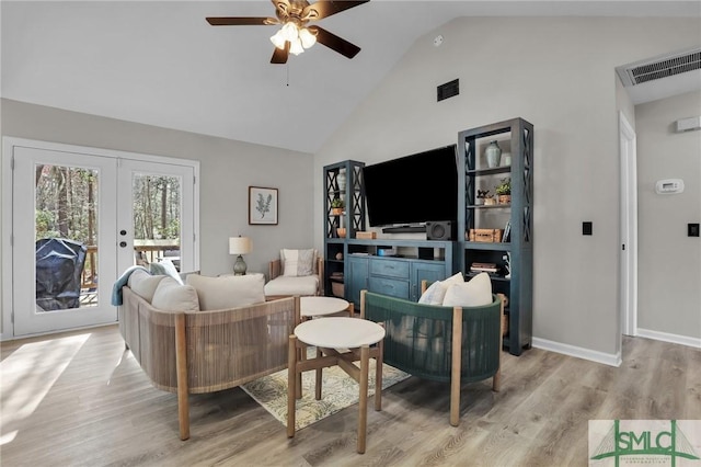 living area with french doors, wood finished floors, visible vents, and baseboards