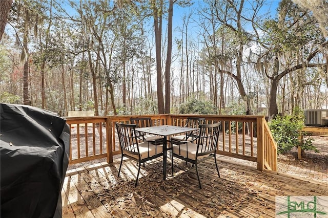 deck with grilling area and outdoor dining space