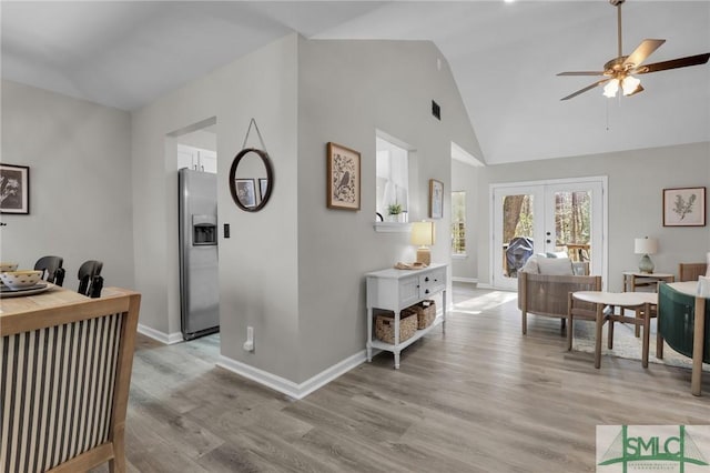 interior space featuring light wood-style floors, french doors, and baseboards