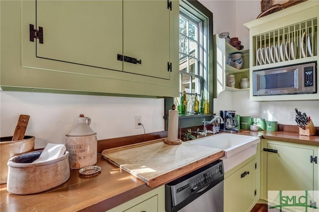 kitchen with open shelves, appliances with stainless steel finishes, and a sink