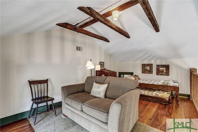 interior space featuring vaulted ceiling with beams, visible vents, baseboards, a ceiling fan, and hardwood / wood-style floors