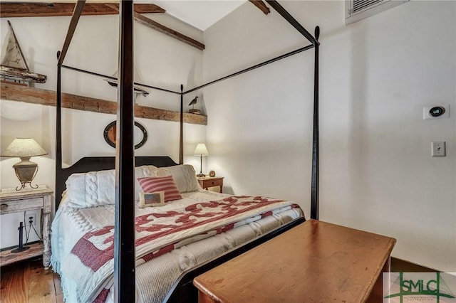 bedroom with wood finished floors and visible vents