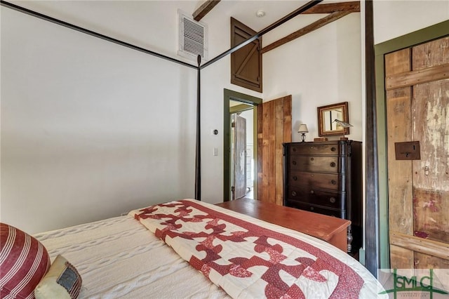 bedroom with a towering ceiling and visible vents