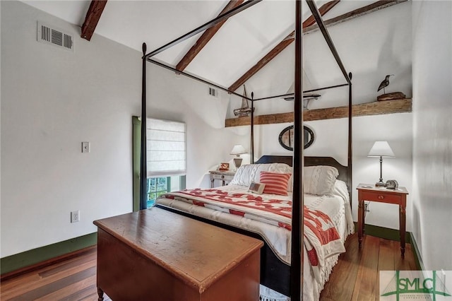 bedroom featuring lofted ceiling with beams, hardwood / wood-style floors, and visible vents